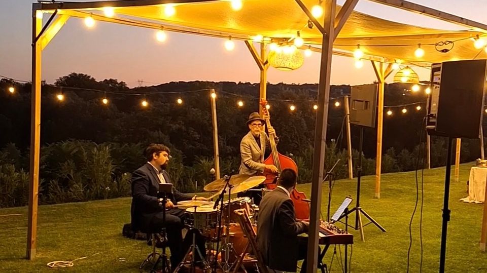 New Orleans actuando al aire libre con piano, contrabajo y batería